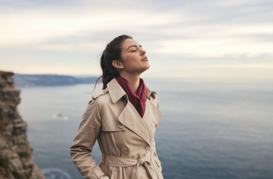 a woman standing next to water with a confident look on her face